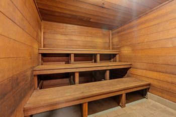 a sauna with wooden benches and a table